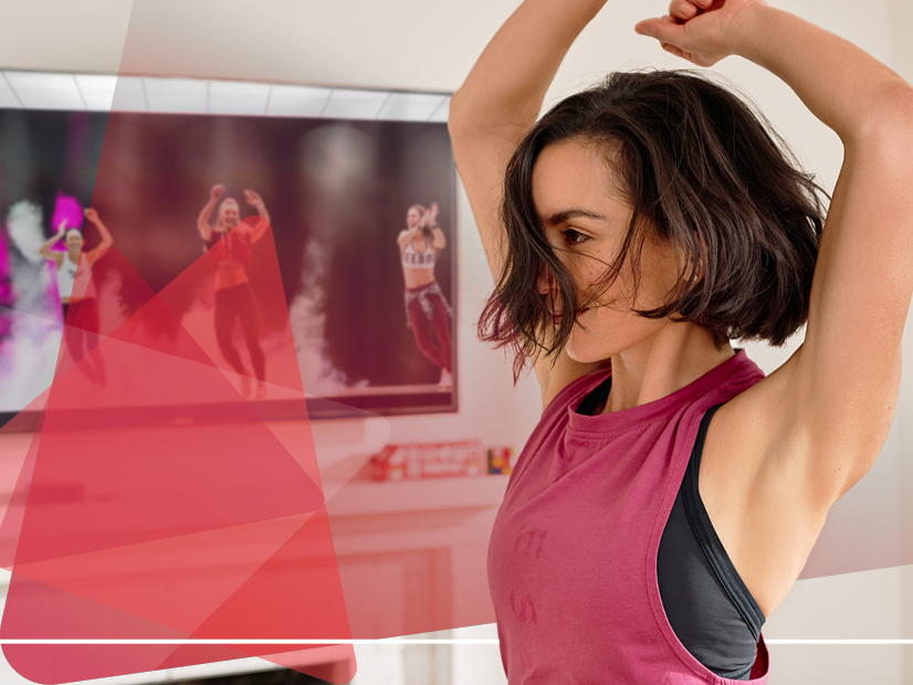 Girl dancing to online dance class in her living room